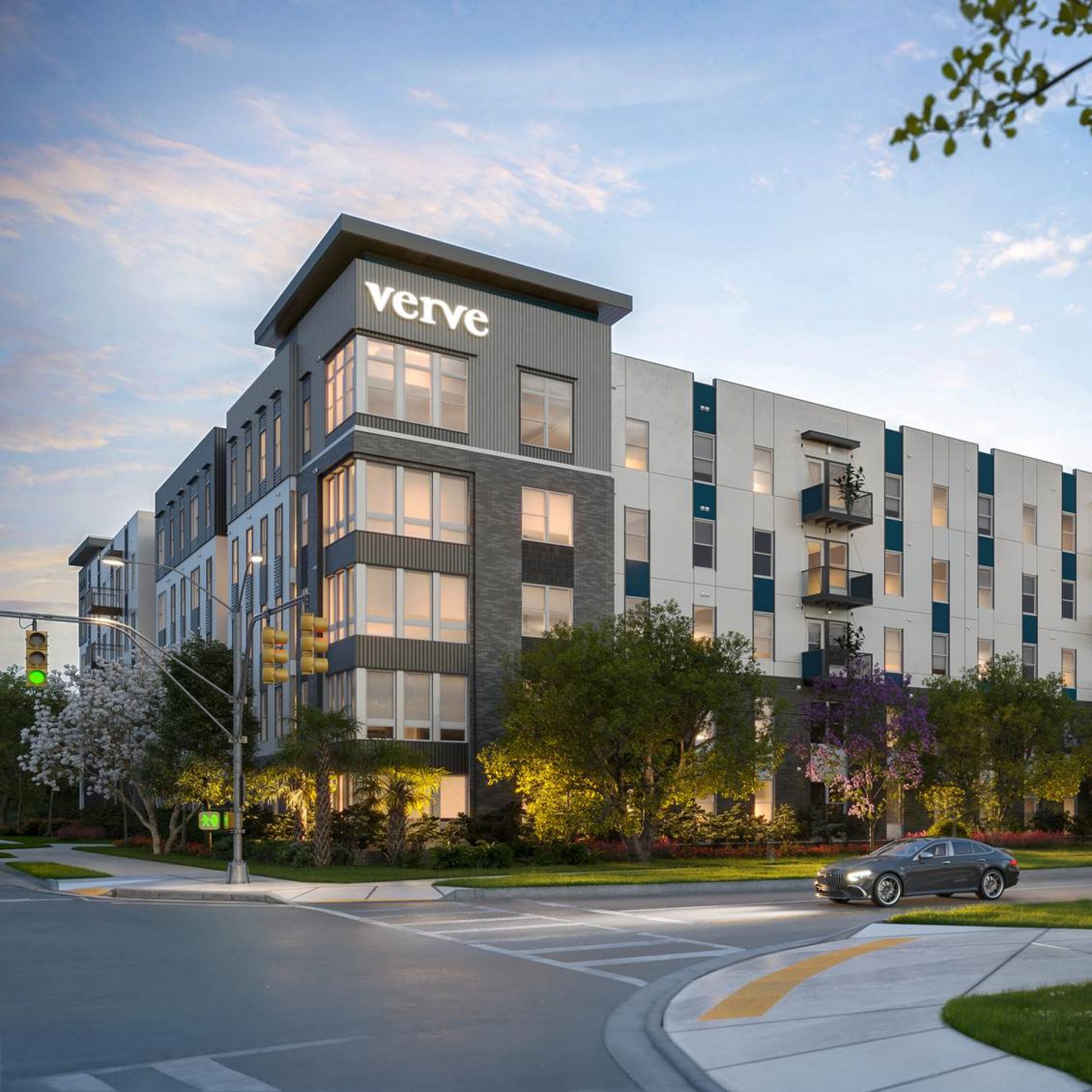 Exterior view of VERVE Orlando showcasing its sleek, modern design with private balconies, lush landscaping, and a roundabout drive under a soft evening sky.